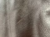 silver shiny leather fabric with a slight pattern on the back of it