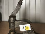 a small metal object on a table with a sticker on it