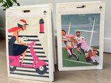 two bags with pictures of people riding scooters on them