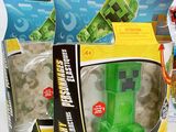 a box of legos with a green minecraft figure in it