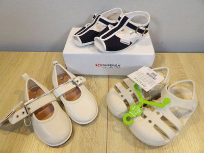 three pairs of shoes that are on a table