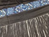 a close up of a black skirt with blue flowers on it