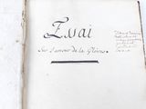 an old book with writing on it sitting on a table