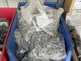 two blue bins filled with assorted items in a warehouse