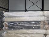 a pile of mattresses sitting on a pallet in a warehouse