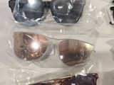 several pairs of sunglasses are sitting on a plastic bag on a table