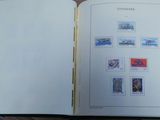 an open book with stamps on it sitting on a table