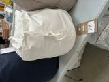 a pile of pillows sitting on a bed in a store
