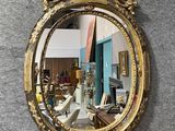 a mirror hanging on a wall in a room