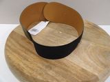 a black belt on a wooden plate on a table