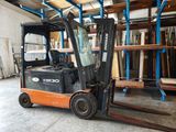 a forklift truck that is parked in a warehouse