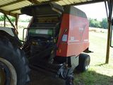 a tractor that is parked under a shelter