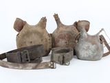 several pieces of old metal items are sitting on a white surface