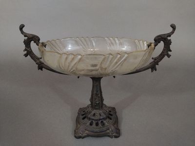 an antique glass bowl on a stand with a bird on it