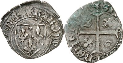 a silver coin with a cross on the front and a shield on the back
