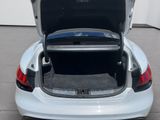 a car with its trunk open in a garage