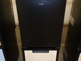 three black and white refrigerators with a price tag on them