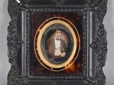 an old picture of a man in a tuxedo in a picture frame