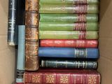 a box full of old books sitting on a table