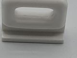 an image of a white plastic stapler on a table