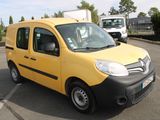 a yellow van that is parked in a parking lot