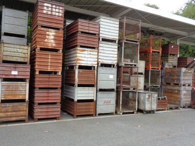 a lot of crates that are stacked on the side of the road