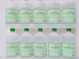 six bottles of liquid sitting on top of each other on a table
