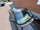 a black car parked on the side of the road next to a building