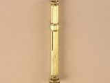 a small brass pipe that is on a beige surface