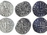 six pièces d'argent anciennes ornées de motifs sur fond blanc