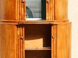 a wooden cabinet with a mirror on top of it