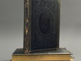 a pair of books sitting on top of each other on a table