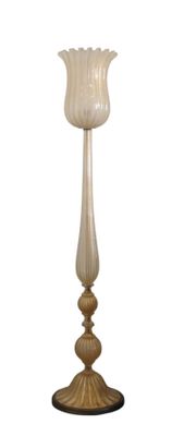 tall glass candle holder with a white flower on top of a wooden base