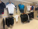 a lot of clothes hanging on the wall in the store