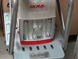 a small machine that is sitting on top of a trash can