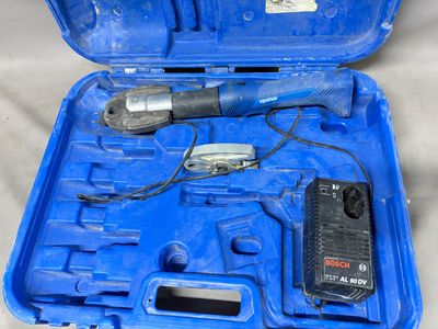 a tool in a blue case that is sitting on a table