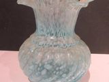 a glass vase that is sitting on a table