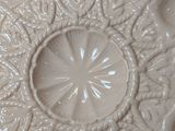 a close up of a white plate with a decorative design
