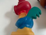toy figurines of a rooster and a chicken on a table