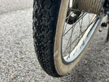 a close up view of a bicycle tire with a chain attached to it