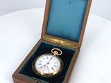 a small wooden box with a clock inside of it
