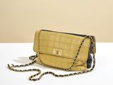 the small quilted bag is on a white table with a chain around it