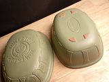 two green plastic containers sitting on a wooden table