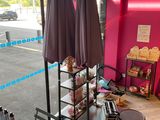 two umbrellas that are on a table in front of a pink wall