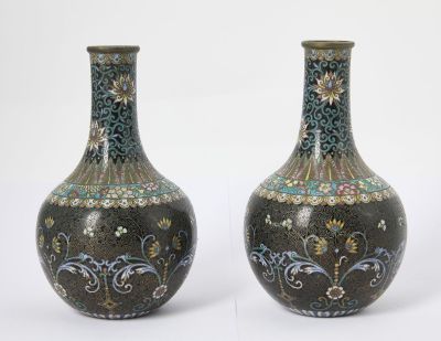 two vases sitting side by side on a white surface