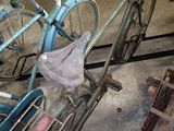 a blue bicycle that is parked in a garage