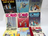 several books of comics are lined up on a white surface