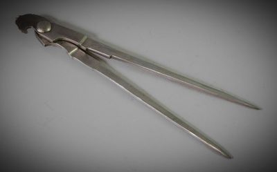 pair of scissors on a white surface with a black background