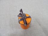 a small orange box with a bow on top of it