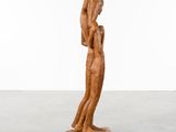 a wooden sculpture of a woman holding a baby in her arms